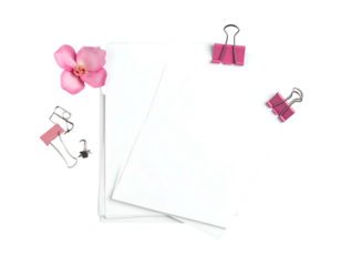 Stack of white paper with pink flower and pink and silver binder clips on a black background