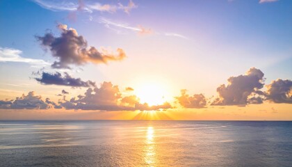 Stunning sunset over the ocean with beautiful sky and fluffy clouds in the horizon