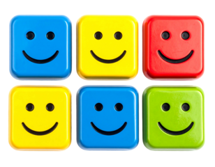 Six square blocks with happy faces arranged in two rows on a dark background with soft lighting