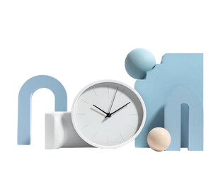 Still life white clock with geometric blue & white shapes set against a black background in bright sunlight
