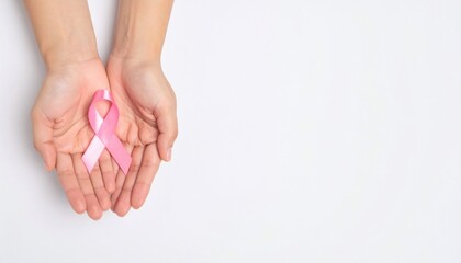 Hands holding pink ribbon on white background supporting breast cancer awareness