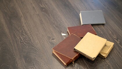 Several vintage leather books laying on the floor