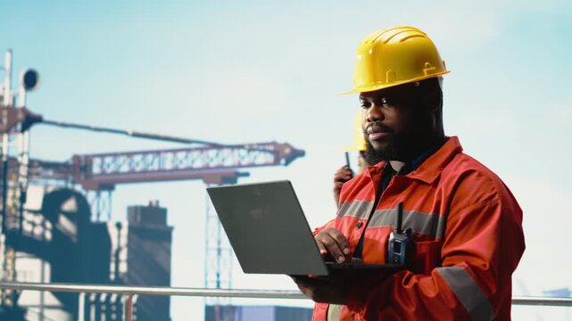 African american worker on offshore platform deck configuring derrick management systems for more efficient oil extraction. Drilling rig ship expert doing seabed analysis using laptop, camera B