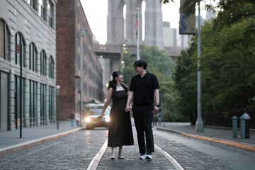 photo of a couple looking at each other lovingly while walking down the street.
