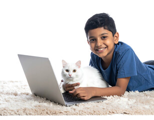 Smiling boy with a fluffy white cat lying next to a laptop on a shag rug against a black backdrop