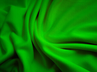 Green crumpled  fabric background. Wavy cloth texture