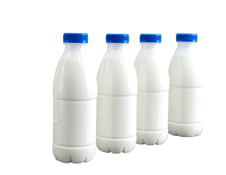 Four plastic bottles filled with white liquid, all capped with blue lids, on a black background, in diagonal alignment