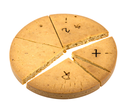 Sliced round tan object marked with math symbols. Close-up on black