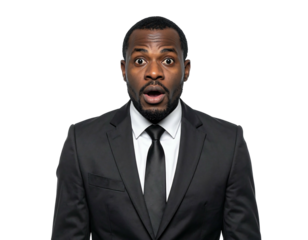 Startled African man in a suit, eyes wide, mouth open in surprise, against a stark black background