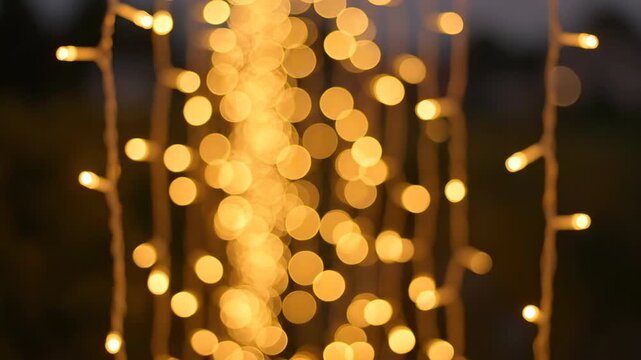 Soft, twinkling string lights with a beautiful bokeh effect captured in a gentle push-in shot, creating a warm and magical atmosphere gentle, tranquil, close up