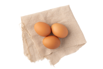 透明背景（png）に布の上に置かれた鶏の卵（赤玉）