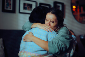 Sad Woman Crying Hugging her Mother Feeling Depressed. Elderly relative offering emotional support for a person experiencing grief 