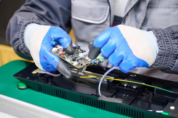 PCB assembly process with gloves in electronics manufacturing environment