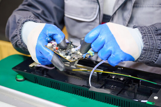 PCB assembly process with gloves in electronics manufacturing environment
