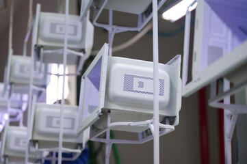 Powder coating process for microwave oven casings on an overhead conveyor in a workshop environment
