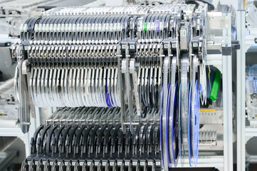 SMT pick-and-place machine with tape feeders showcasing precision component placement in a manufacturing facility