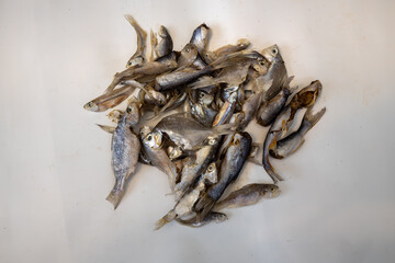 Pile of Small Dried Fish on White Background.