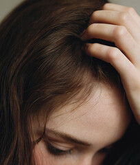Woman scratching scalp feeling itching and discomfort