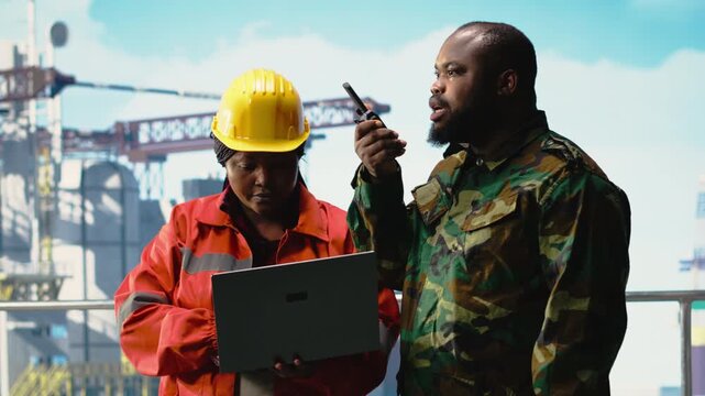 Soldier working on offshore platform issuing command over radio transmission. Military unit boarding drilling barge under maritime interdiction protocol, monitoring perimeter, camera B