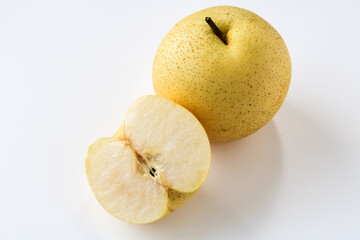 A fresh Asian pear, with one whole fruit and another cut in half to reveal its crisp, white flesh and core, isolated on a clean white background.