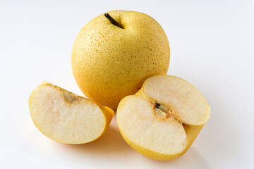 A fresh Asian pear, with one whole fruit, slice and another cut in half to reveal its crisp, white flesh and core, isolated on a clean white background.