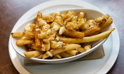 Classic Poutine featuring fries, cheese curds, and savory brown gravy.