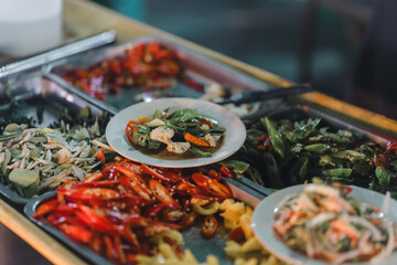 Stir-fried food, being served on a plate, being served on a plate