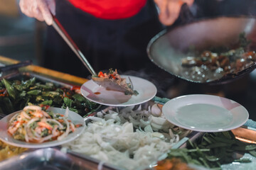 Stir-fried food, being served on a plate, being served on a plate