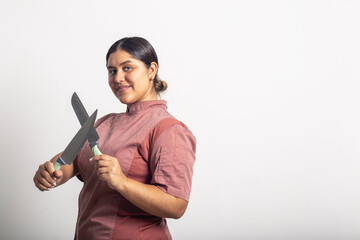 Professional woman chef posing with kitchen knives