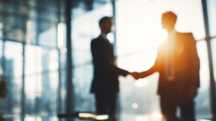 Business professionals shaking hands in a bright office setting, representing successful partnership and collaboration in a modern corporate environment