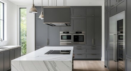 Modern kitchen interior showcases a marble-topped island with built-in stovetop, stainless steel appliances, and gray cabinetry creating a contemporary aesthetic.