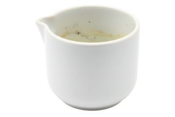 Dirty white ceramic creamer pitcher with coffee stains inside isolated on a transparent background