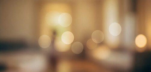 A softly glowing abstract background bathed in warm golden tones, featuring delicate circular light blurs that create a tranquil, atmospheric, and elegant visual harmony.