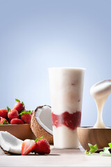 Fresh coconut strawberry smoothie drink – healthy summer beverage with tropical fruits and creamy yogurt