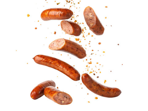 Delicious grilled sausage meat food falling with sliced pieces and spice. Tasty isolated barbecue snack transparency background for menu