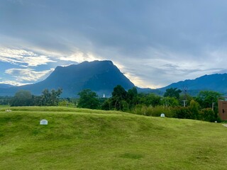 Green yard with mountain chiang dao located in Chiang mai northern part of Thailand