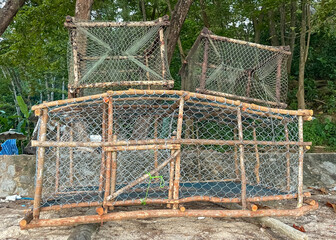Fototapeta premium New wooden traps with metal mesh used by local fishermen to catch crabs and fish in the coastal waters of Phuket.
