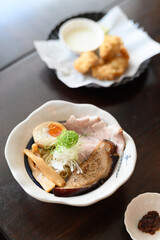 Delicious bowl of authentic japanese ramen with pork and soft boiled egg at cozy restaurant. warm and comforting meal enjoyed with tasty side dish for lunch