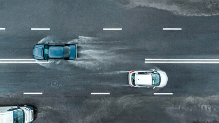 road traffic in rainy weather. cars driving on flooded street after heavy rain. dangerous driving conditions. aerial panoramic view.