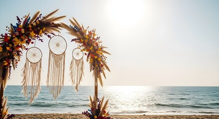 Bohemian wedding arch decorated with flowers and dream catchers on a sunny beach, ideal for a romantic ceremony.