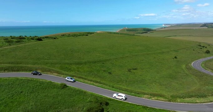 Driving On The Road Along The Seven Sisters Cliffs On The English Channel Coast In East Sussex, England. Aerial Tracking Shot