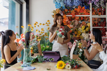 Women learning floral arrangement in workshop receiving applause