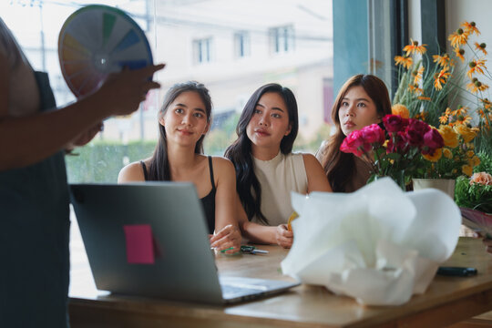 Women learning floral design during creative workshop