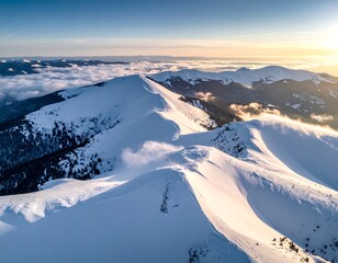 Aerial view of snow-capped mountains under a warm, golden sunrise sky