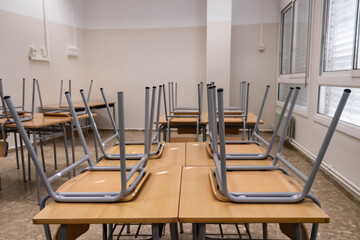 Empty classroom with chairs placed on desks