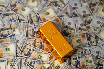 Golden bars on US dollars background. Gold bar and money. Gold bars for savings capital. Dollars money and gold concept. Financial success and saving Gold.