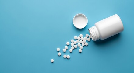 White bottle of pills spilled on a blue background, representing medication and health