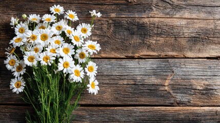 Obraz premium Wildflowers and wooden table background created concept. A beautiful bouquet of daisies on a rustic wooden background.