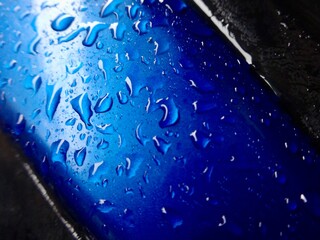 close-up of raindrops on the side bumper