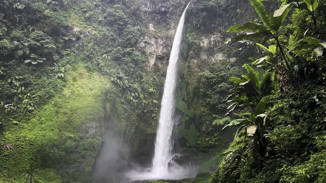 view of Pelangi Waterfall in Malang, east java, Indonesia. Stunning jungle scene with cascading streams and lush green tropical vegetation